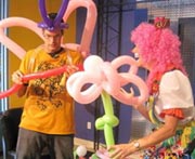 Tim Ezell tries to make a balloon animal with Silly Jilly the Clown